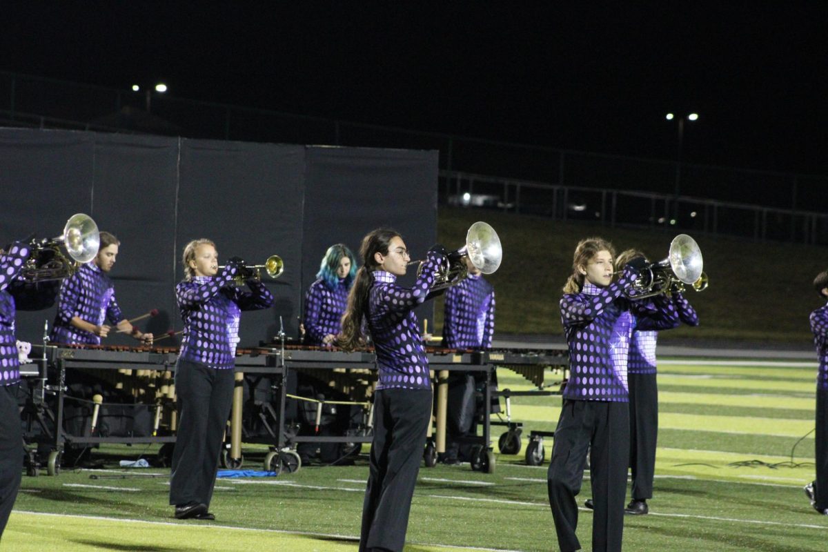 Marching Band Performing their show during halftime of a football game.