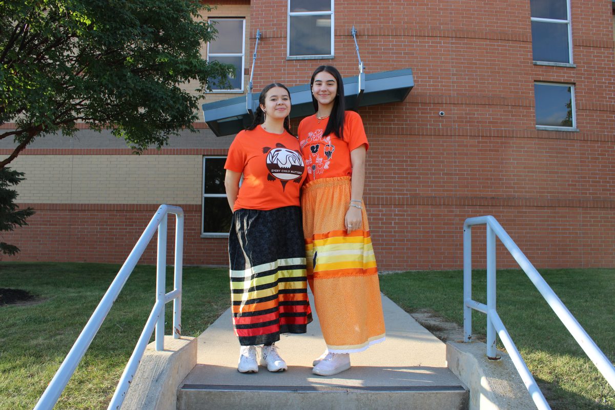 Sereniti Cole and Tayla Sizemore in their homemade ribbon skirt and orange shirts