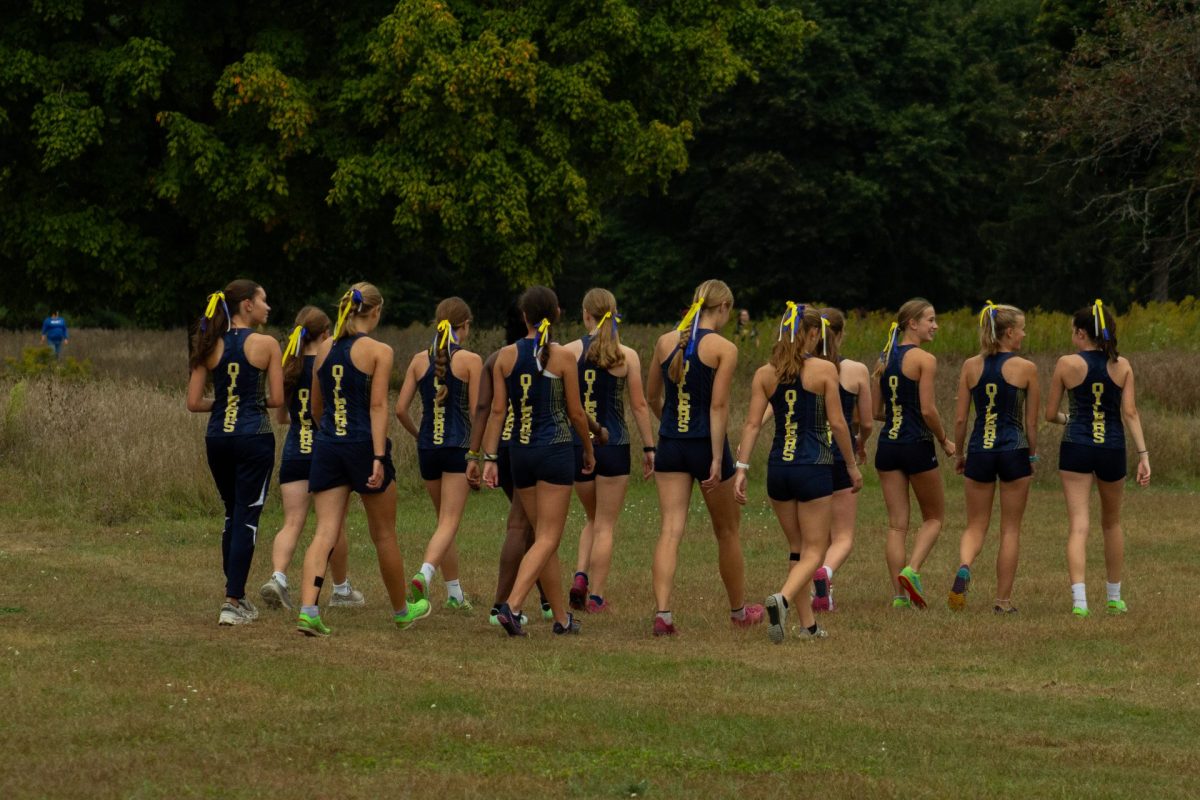 The girls team walks a course ahead of their race to prepare.